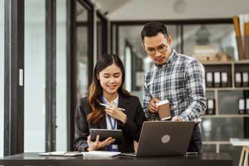Young businesswoman and other Asian individuals are seen working at desks. Accountability, faultfinding, negligence, and other aspects of recruitment, staffing, and talent management being discussed.