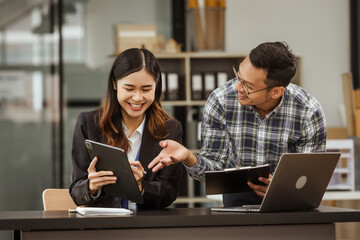 A middle-aged businessman, a young businesswoman, and Asian individuals are collaborating at desks. They engage in teamwork while managing commodities, trade, finance, and talent acquisition.