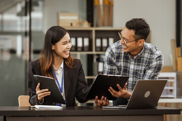 A middle-aged businessman, a young businesswoman, and Asian individuals are collaborating at desks. They engage in teamwork while managing commodities, trade, finance, and talent acquisition.