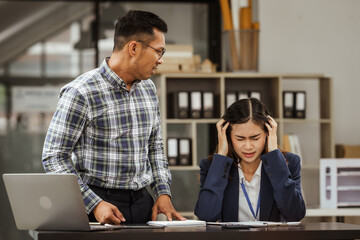 Young businesswoman and other Asian individuals are seen working at desks. Accountability, faultfinding, negligence, and other aspects of recruitment, staffing, and talent management being discussed.