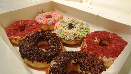 Photo of donuts in a box with various variants, food product photography
