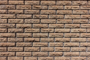 Texture of brown split face brick veneer wall with stretcher bond pattern