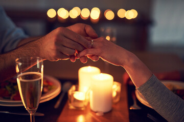 Night, hands of couple and proposal ring on date in restaurant for engagement, romance, commitment...