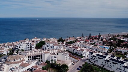 Aerial view of architecturally-designed modern prestige homes with pools in outer suburban Spain