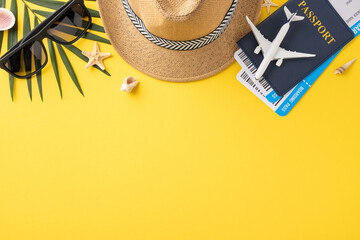 Flat lay image of summer travel essentials including straw hat, sunglasses, passport, and shells on...