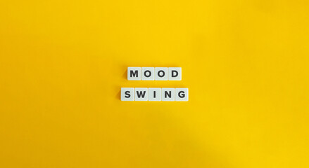 Mood Swing Term and Concept Image. Intense Change in a Person's Emotional State and Behavior. Text on Block Letter Tiles on Yellow Background. Minimal Aesthetics.