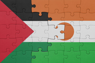 puzzle with the colourful national flag of niger and flag of palestine.