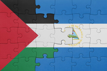 puzzle with the colourful national flag of nicaragua and flag of palestine.