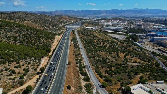 Aerial tracking shot of rush hour traffic on the A8 highway, sunny day in Greece