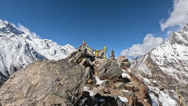 Arrival on the rocky summit with prayer flags. ascending Kyanjin Ri Mountain.  Kyanjin Gompa. Langtang Valley Trek, Himalayas of Nepal.