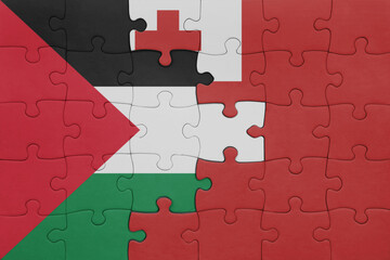 puzzle with the colourful national flag of Tonga and flag of palestine.