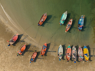 Aerial shot of a tranquil body of water with several boats floating on the surface