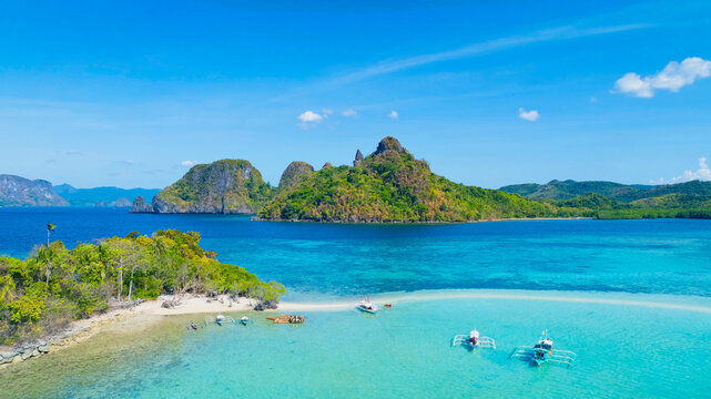 Aerail view of  tropical exotic island sand bar separating sea in two with turquoise  in El Nido, Palawan, Philippines.