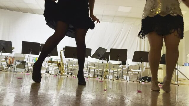 Girls legs video Expression dancing swing dance in the empty ball hall. Women dressed sexy dresses, stockings, high heels shoes. Retro style funny time spending 4K footage.