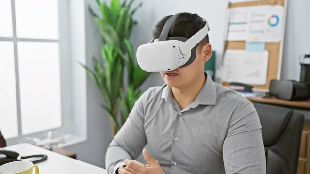 Young asian man using virtual reality headset in modern office setting, expressing curiosity and innovation.