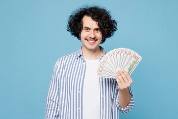 Young smiling man he wear shirt white t-shirt casual clothes hold in hand fan of cash money in...