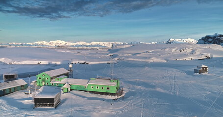 Antarctica Ukrainian polar station Vernadsky, aerial drone view. Stunning winter landscape. The snow covered land and mountains surrounded by cold ocean. The harsh environment on south pole continent © mozgova