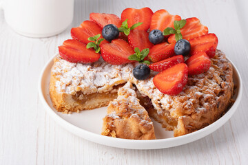 Fruit cake decorated with strawberries and blueberries