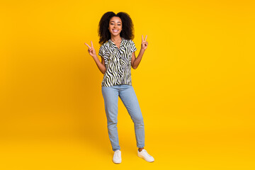 Portrait photo of glamour young charming woman curly hair in zebra print shirt makes v sign...