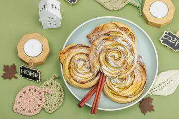 Apple roses pie with sugar powder. Traditional autumn baking, fall decor, flat lay