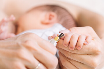 Mother Trimming Newborns Fingernails