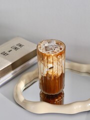 glass of coffee with milk, standing on the mirror