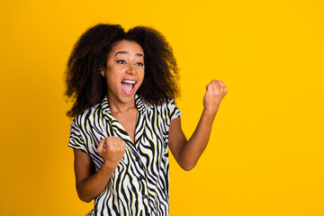 Portrait photo of young funky girlfriend in zebra print shirt with beautiful curly hair winning...