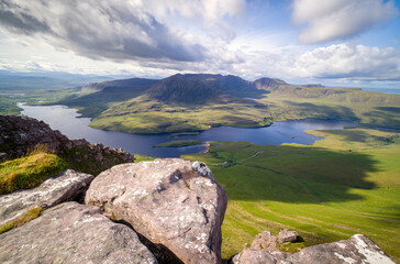 Views of Sgorr Tuath and Loch Lurgainn with Beinn an Eoin, Sgurr an Fhidhleir, Ben More Coigach and Beinn nan Caorach behind from the summit of Stac Pollaidh in the Scottish Highlands