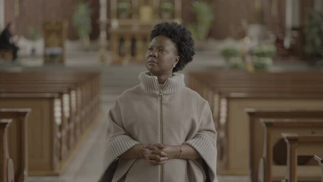 Young African Woman With Curly Hair Praying Inside Church