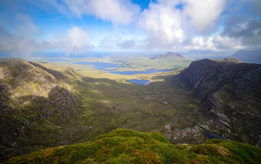 Views of Stac Pollaidh, Suilven and Cul Mor with Ben More Coigach and Sgorr Tuath closest, from the summit of Sgurr an Fhidhleir with Loch Lurgainn and Loch Dearg below in the Scottish Highlands.