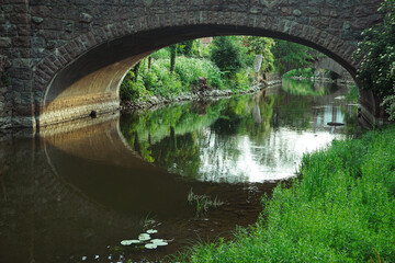 Fototapeta premium A beautiful stone bridge over a canal