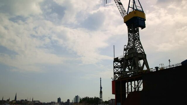 passing by the silhouette of cranes in Hamburg port, Germany