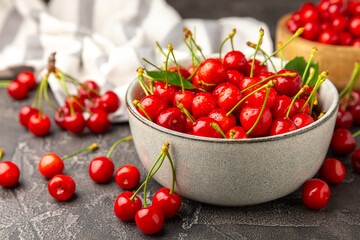 Cherries. Fresh ripe cherries with leaves on a textured wooden background. Fresh sweet organic...