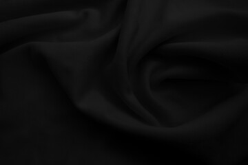 Black cloth blackground. Dark wavy fabtic.