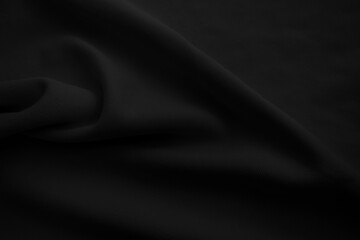 Black cloth blackground. Dark wavy fabtic.