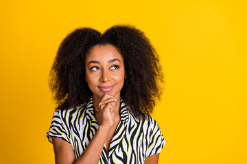 Portrait of young intelligent touch chin woman in zebra print shirt with beautiful curly hair...