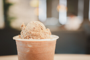 A refreshing ice cream float on Mocha coffee frappe against a backdrop of blur light background.