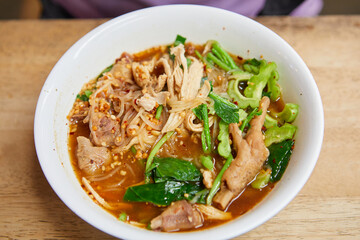 Rice stick noodles with braised chicken meat in a bowl