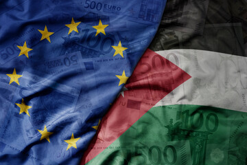 big waving realistic national colorful flag of european union and national flag of jordan on a euro money banknotes background.