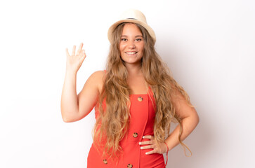 A young caucasian attractive blonde woman with wavy hair showing okay gesture with her hand isolated on a white background.