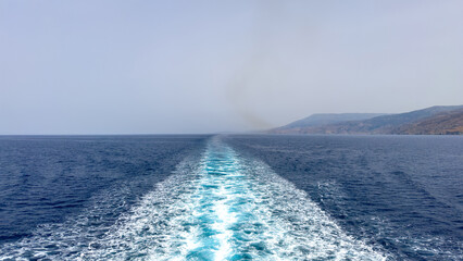 Mediterranean sea. Boat white wake, on blue sea and sky background, view from the ship