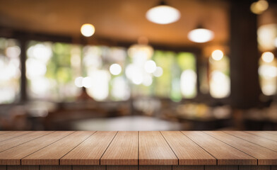 Empty wooden table top with lights bokeh on blur restaurant background.
