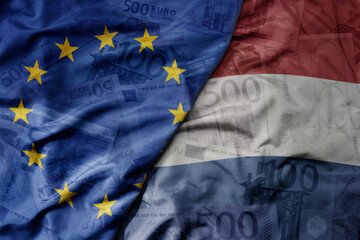 big waving realistic national colorful flag of european union and national flag of netherlands on a...