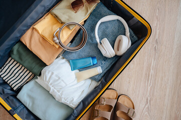 Packing suitcase for travel vacation in new normal, top view.