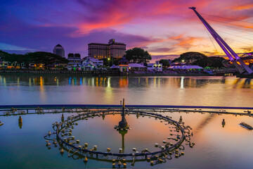 view of the river and fountain equipment and bridge at dusk