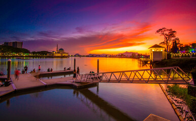 the view of the river and the pier in the red twilight