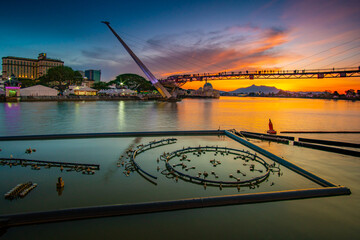 view of the river and fountain equipment and bridge at dusk