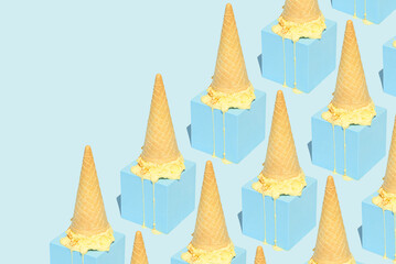 Ice cream melting on a cube arranged in a pattern on a blue background. Summer aesthetic sweet food concept with diagonal copy space.