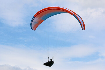 Paraglider flying in a blue sky	
