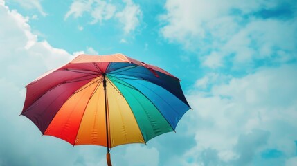 Flying Umbrella rainbow colorful in front of sky background pride day background